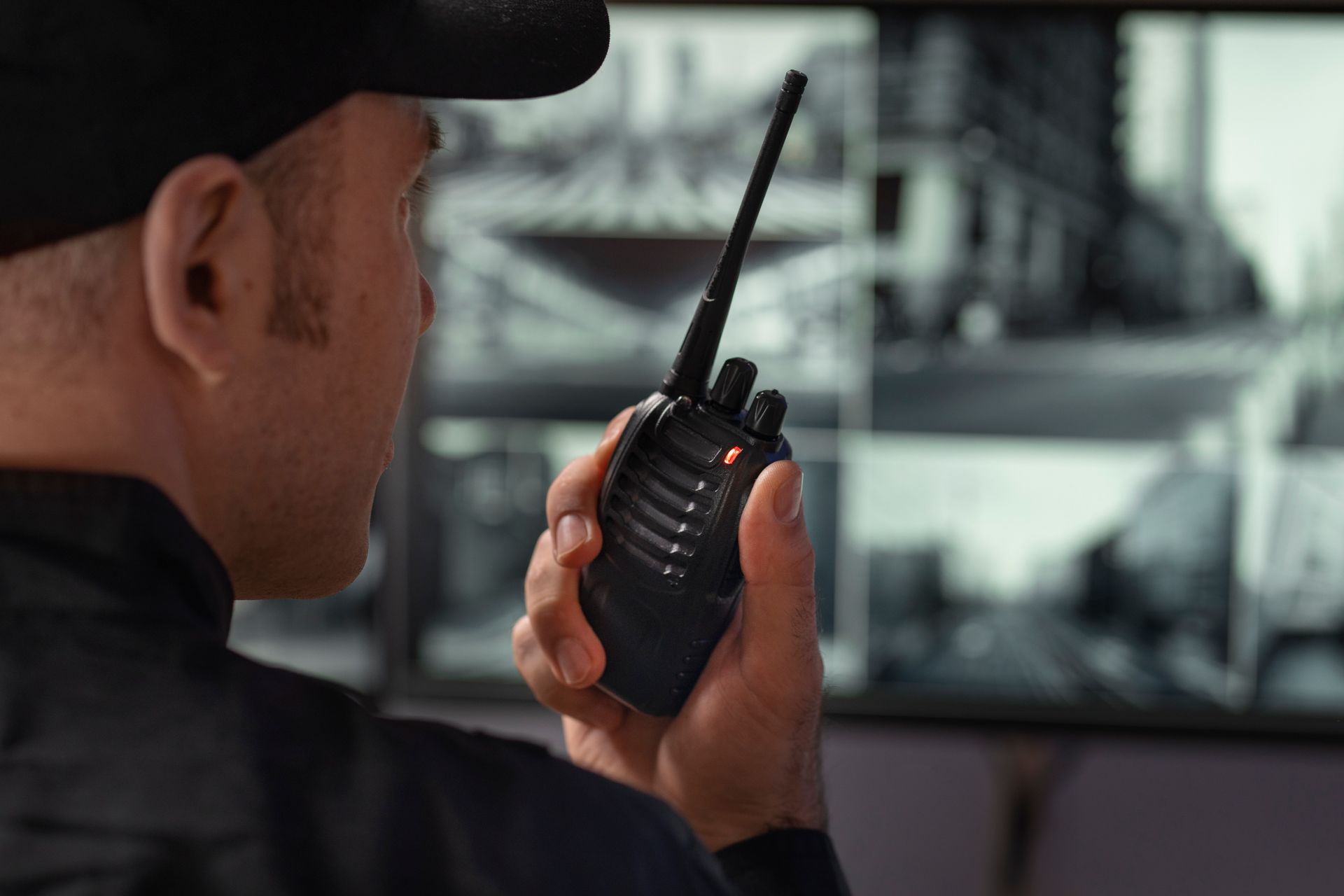 A man in a suit is talking on a walkie talkie while walking with a family.