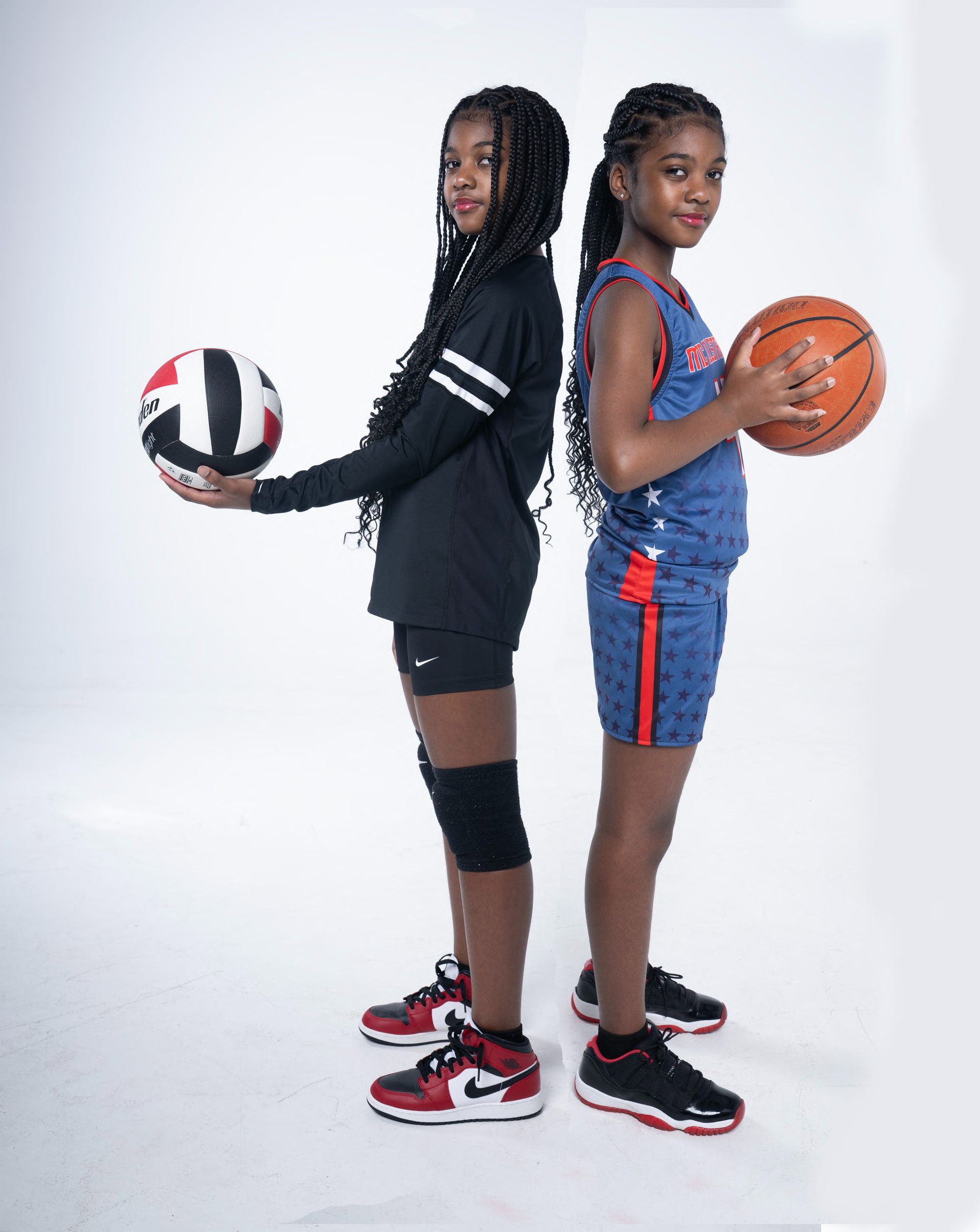 Two athletes standing back-to-back, holding a volleyball and basketball on a white background