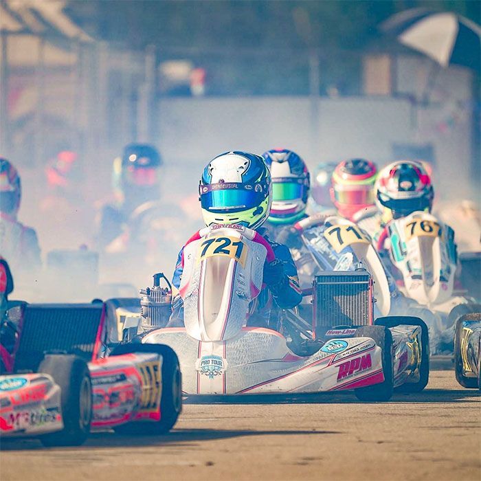 A group of people are racing go karts on a track.
