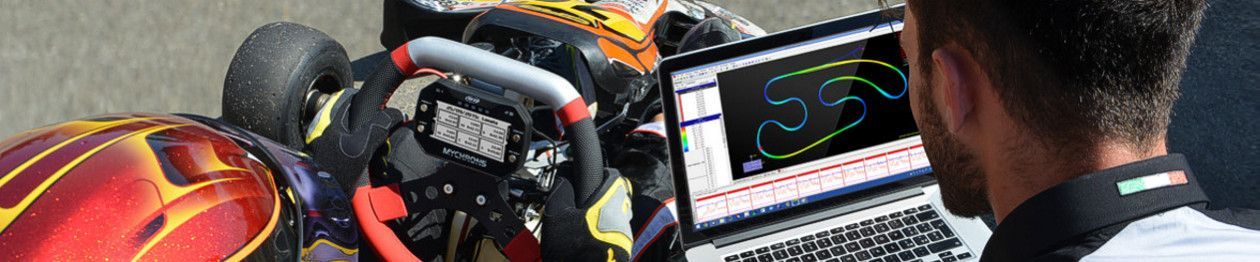 Max Opalski is looking at a laptop with racing data and a track map in front of a go-kart.