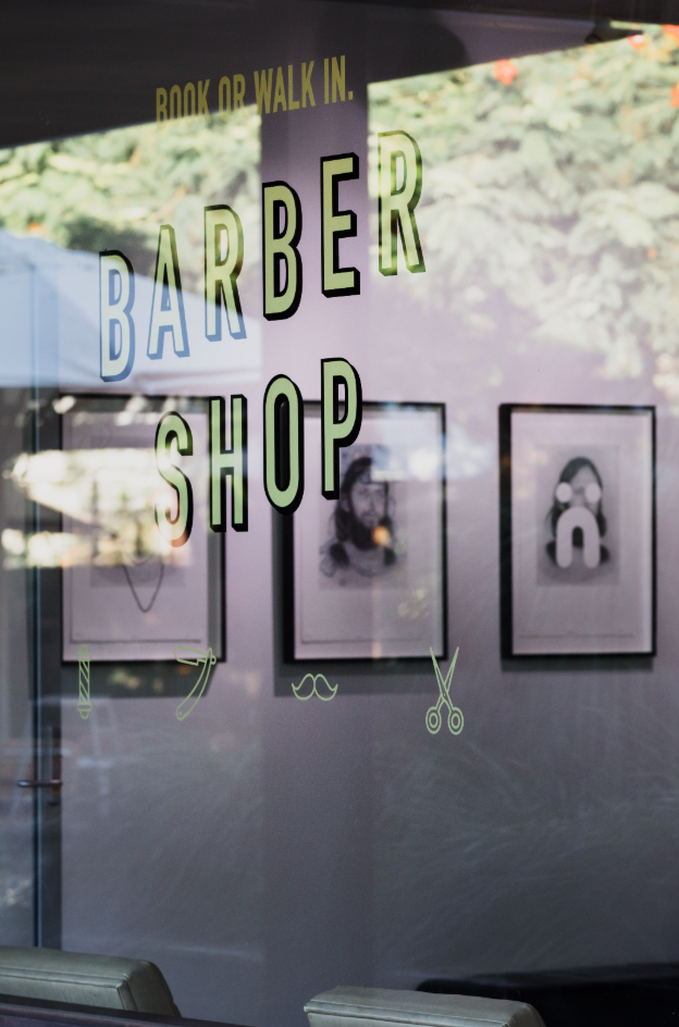 a Man is Getting His Hair Cut by a Barber in a Barber Shop — Habitat Barbershop Byron Bay In Byron Bay, NSW