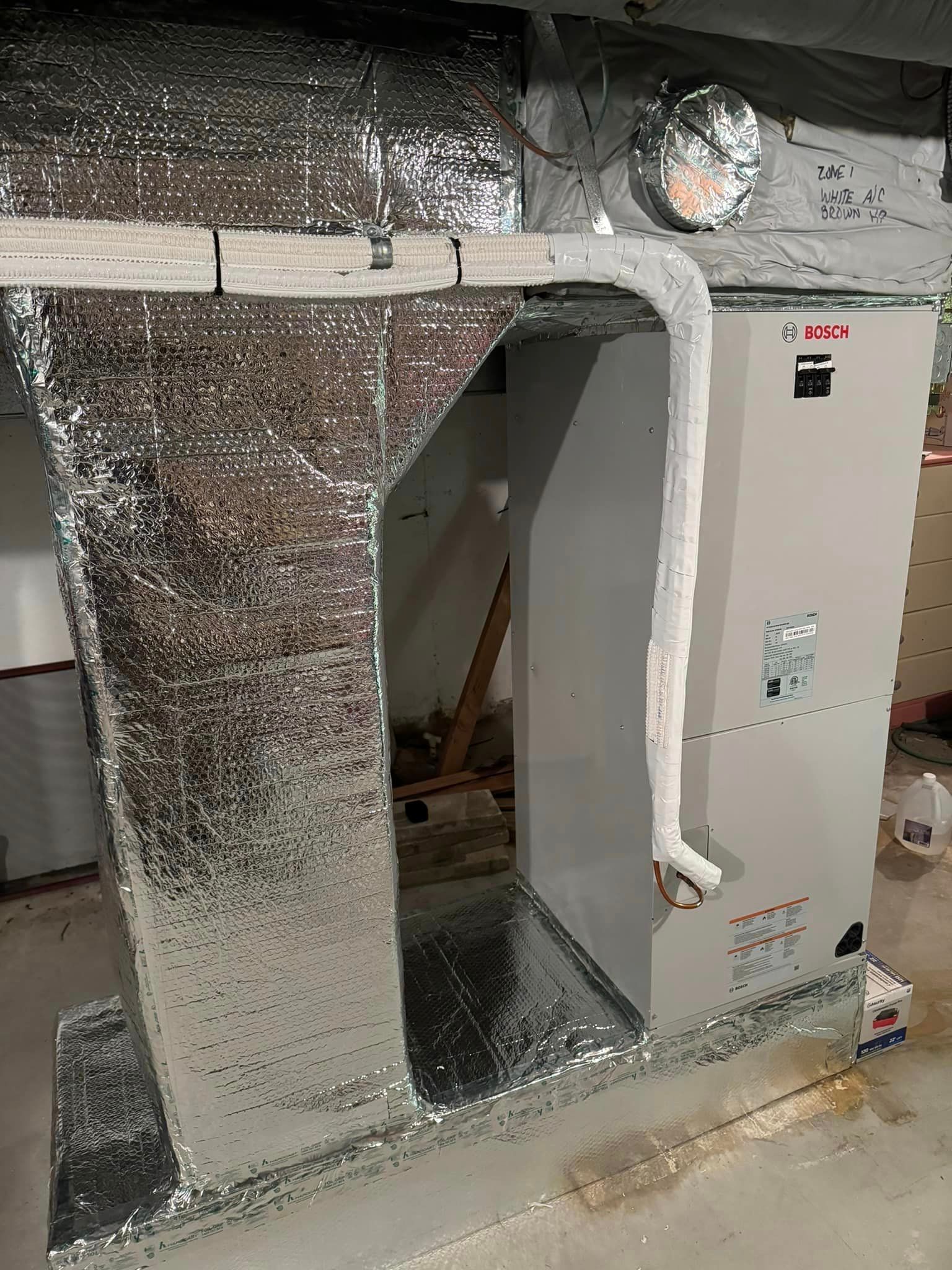 A room with a heater and a pipe coming out of it.