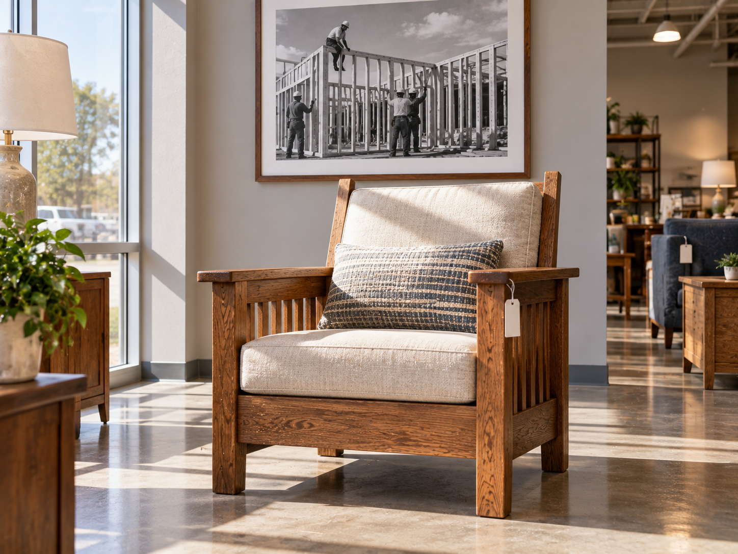 Donated wooden armchair on a sunlit store floor with a framed build site photograph on the wall
