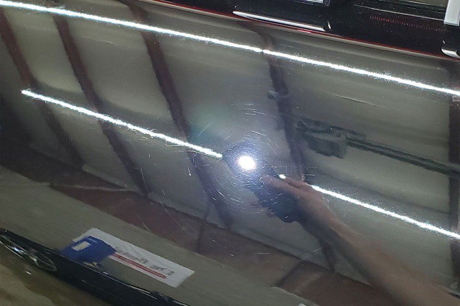 a person is holding a flashlight in front of a mirror .