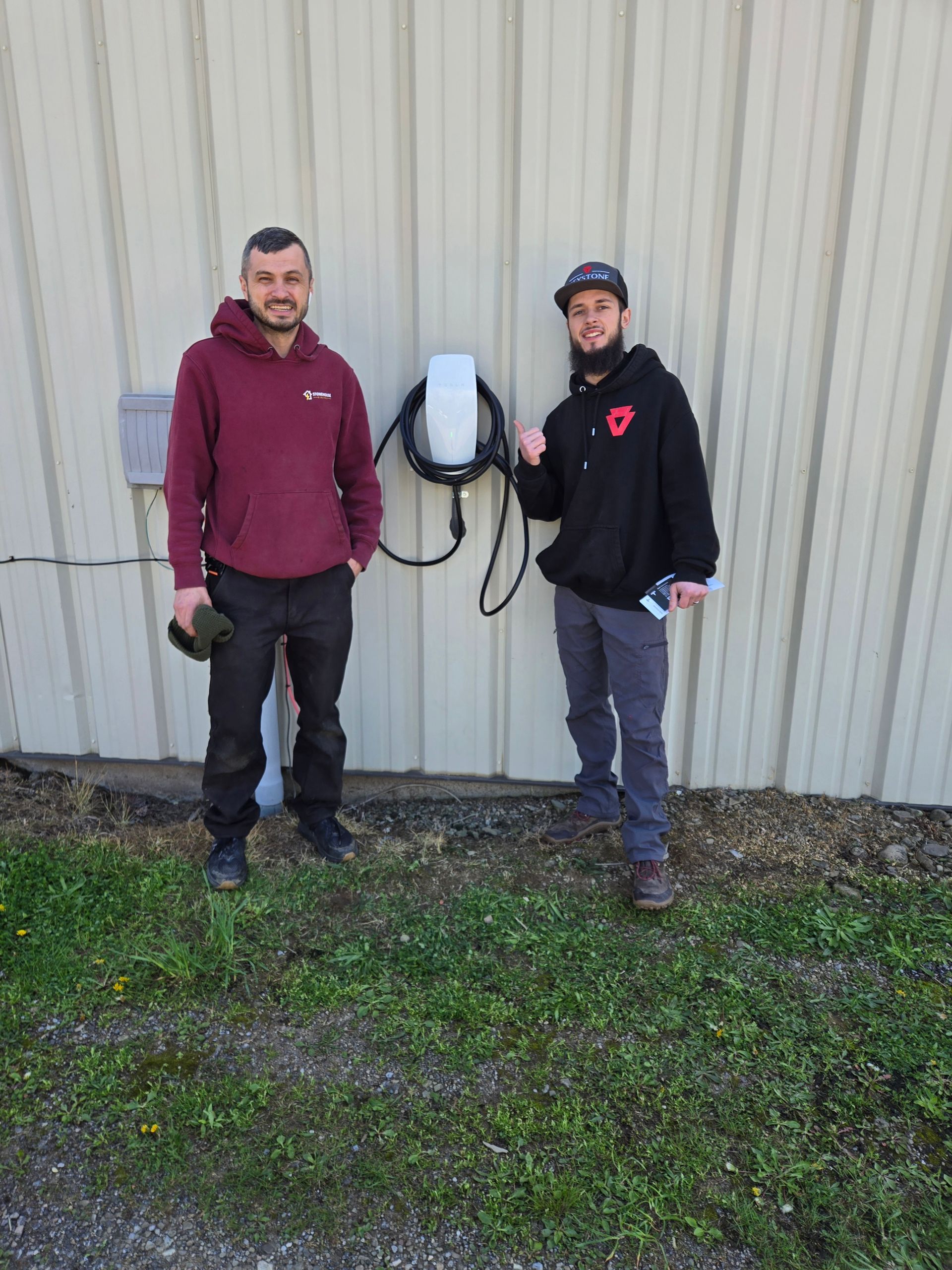 Stonehouse Electric installer with the newly mounted Tesla wall charger at Keystone Detail in Waterford, PA