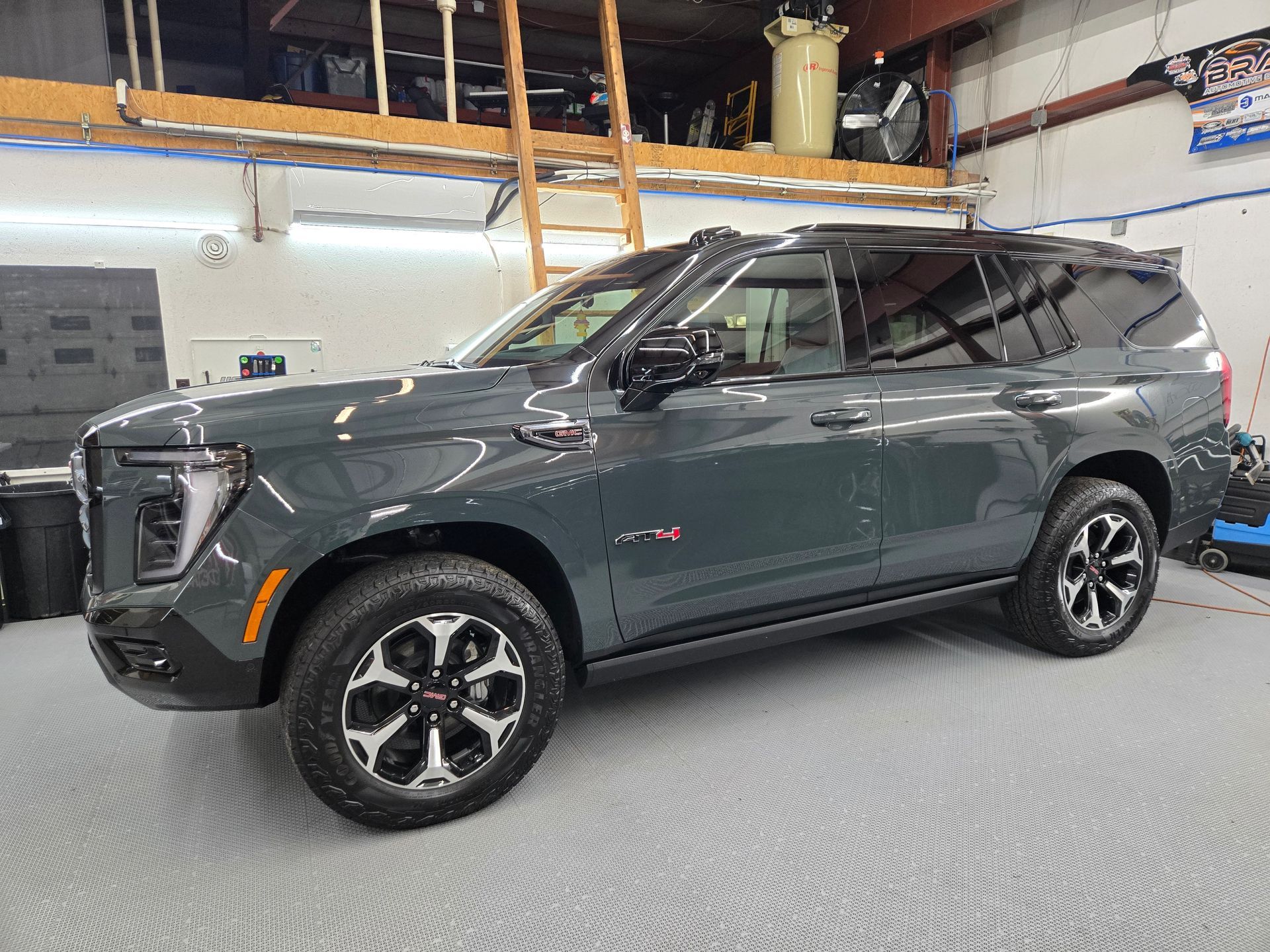 GMC Yukon AT4 inside Keystone Detail shop after tuxedo wrap and black PPF installation