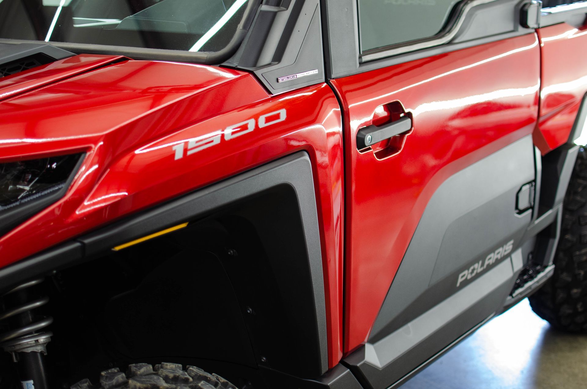 Red and black off-road vehicle side door with “T300” decal and rugged trim