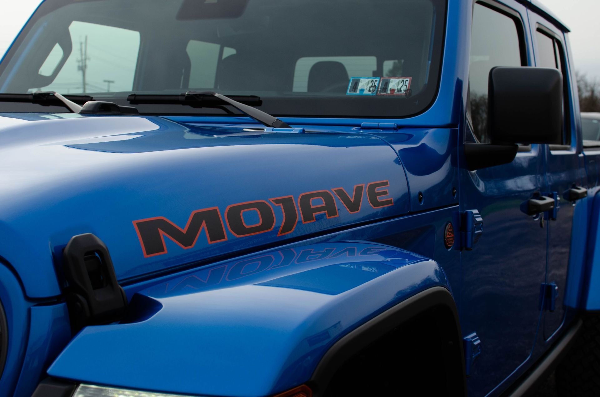 Blue Jeep Mojave with black fender flares, close-up front side view.