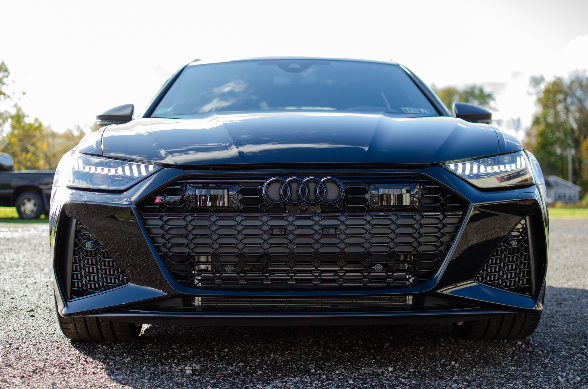 Front view of a black Audi car parked on gravel outdoors