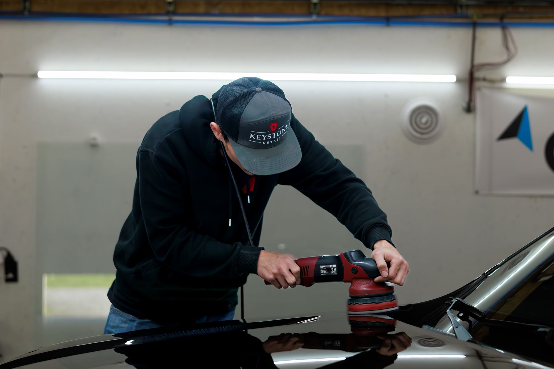 Polishing and buffing a hood on a car to prep for ceramic coating