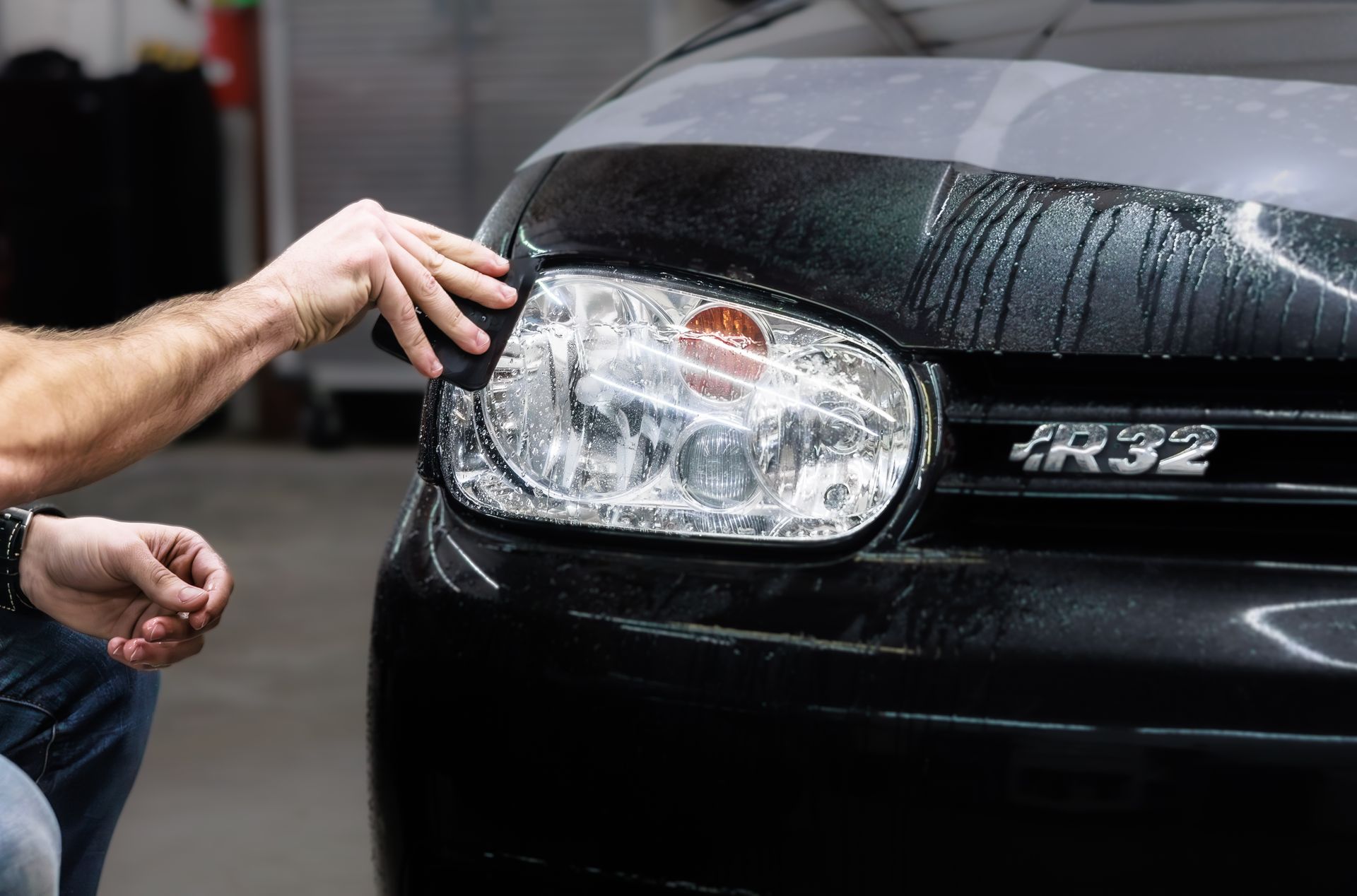 Keystone Detail installer applying paint protection film to a vehicle headlight in Waterford, PA