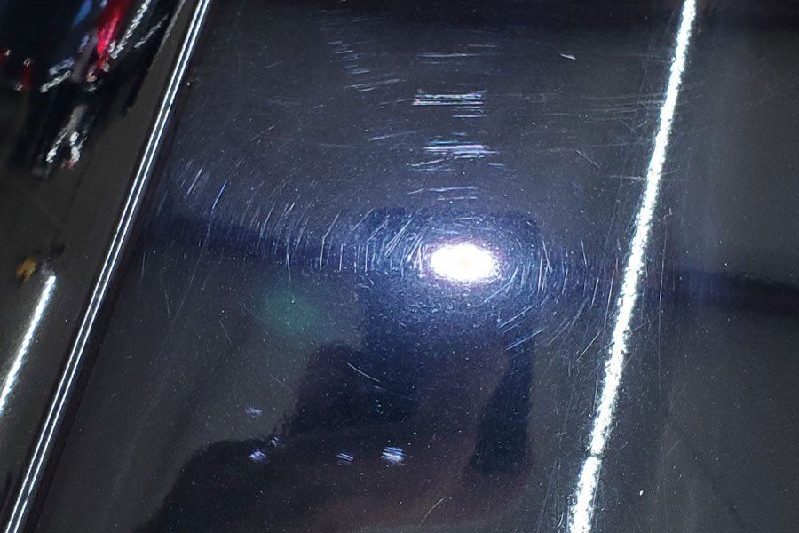 a person is taking a picture of a car with a camera .