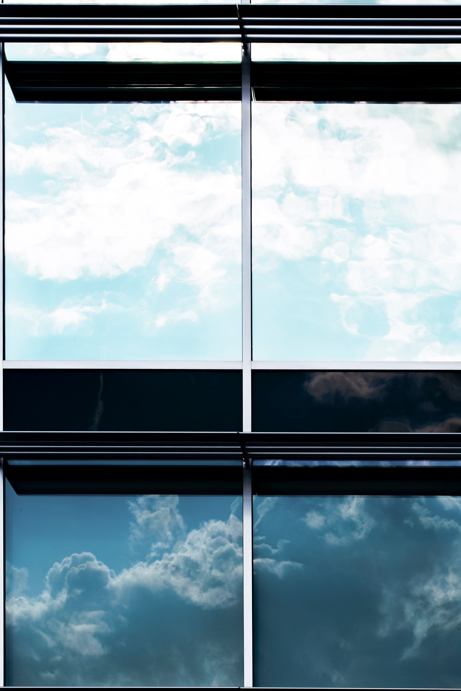 Sky and clouds seen through a window with white mullions