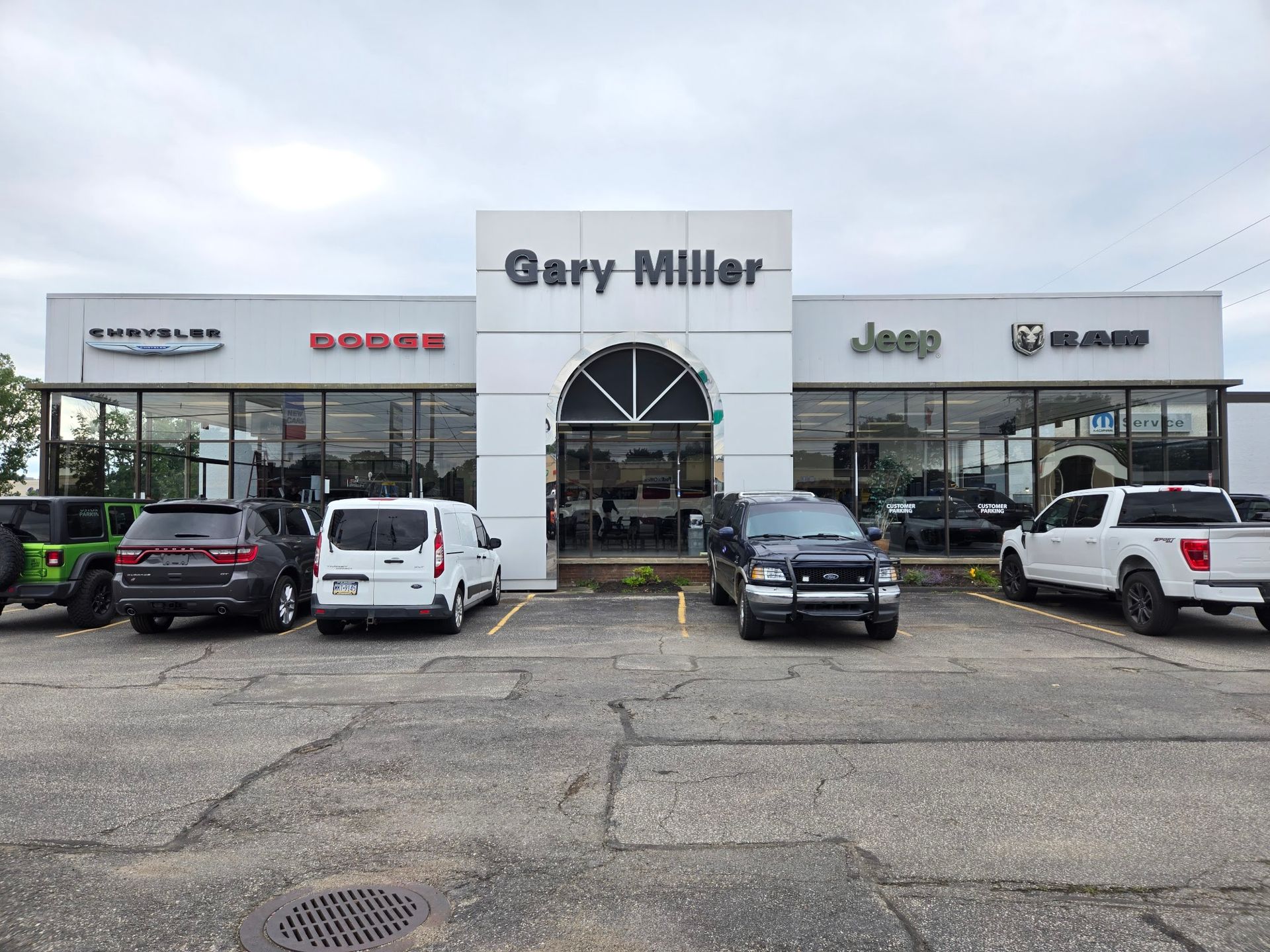 Gary Miller Chrysler dealership storefront in Erie, PA before commercial window film was installed