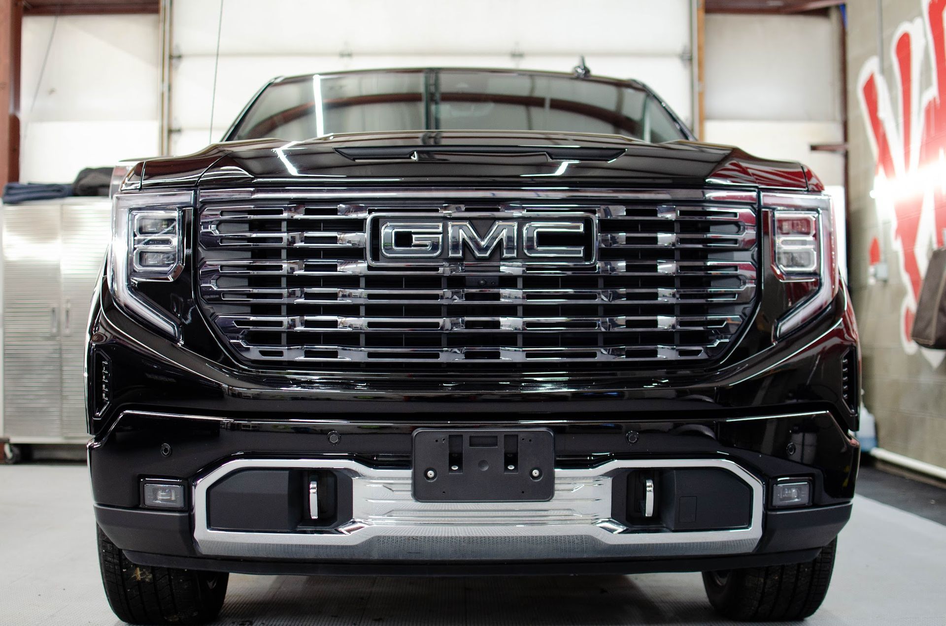 Deep gloss on the front grille of a ceramic coated GMC Sierra Denali in Waterford, PA