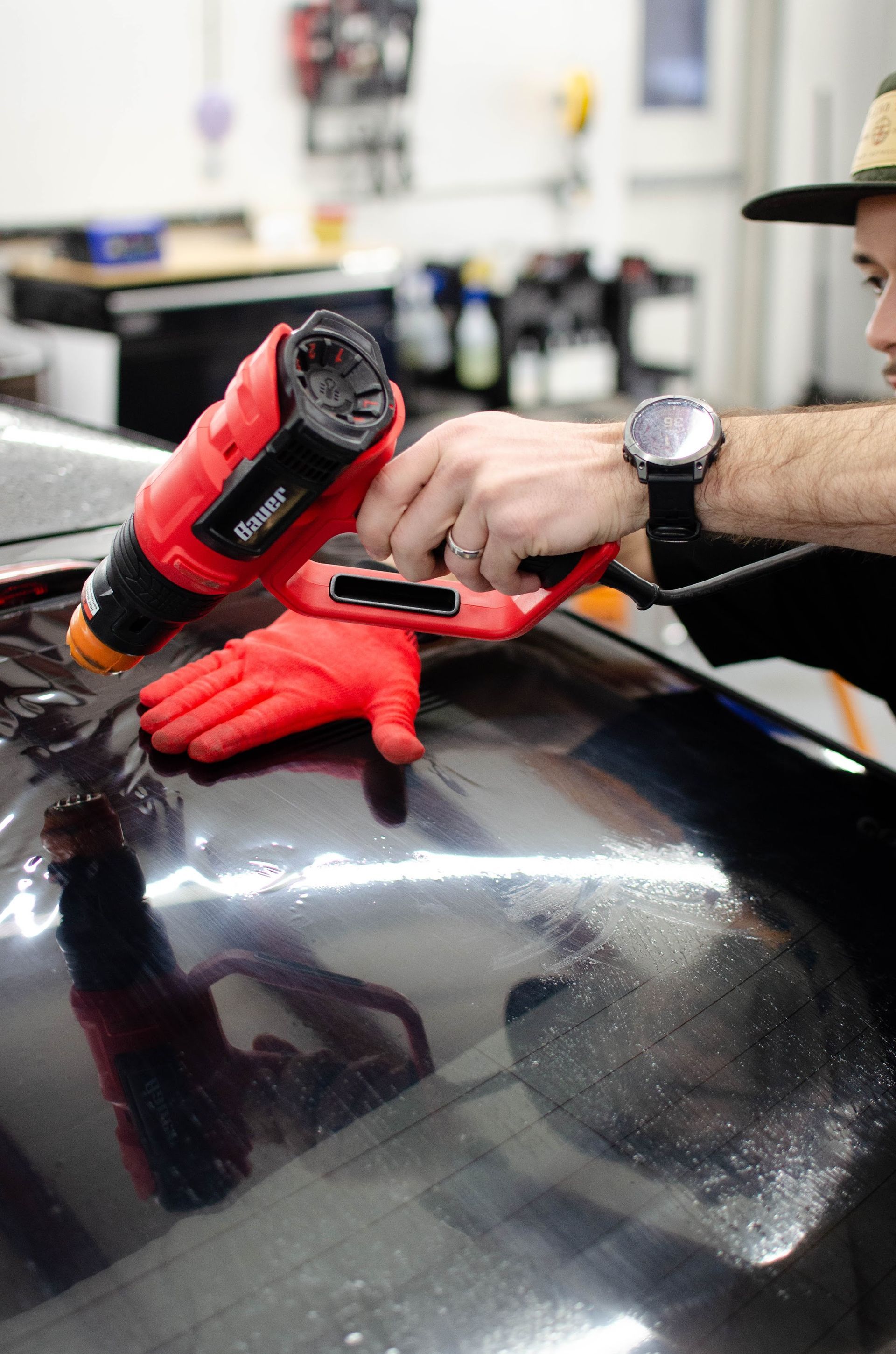 Close-up of window tint film being shrunk to the curve of the glass in the Waterford, PA shop
