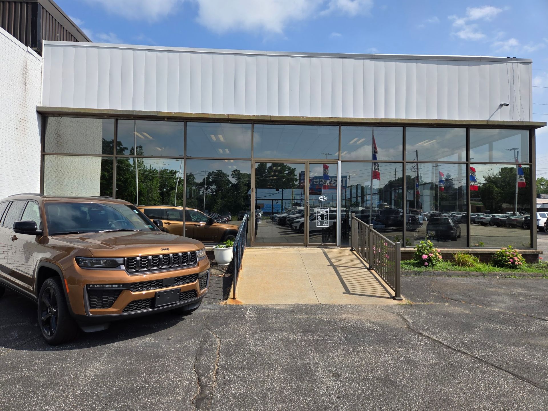 Finished showroom entrance with commercial window tint at Gary Miller Chrysler in Erie, PA