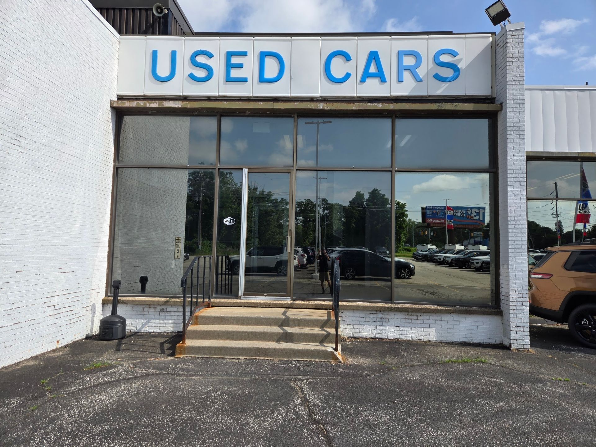 Used vehicle building with new commercial window film at a dealership in Erie, PA
