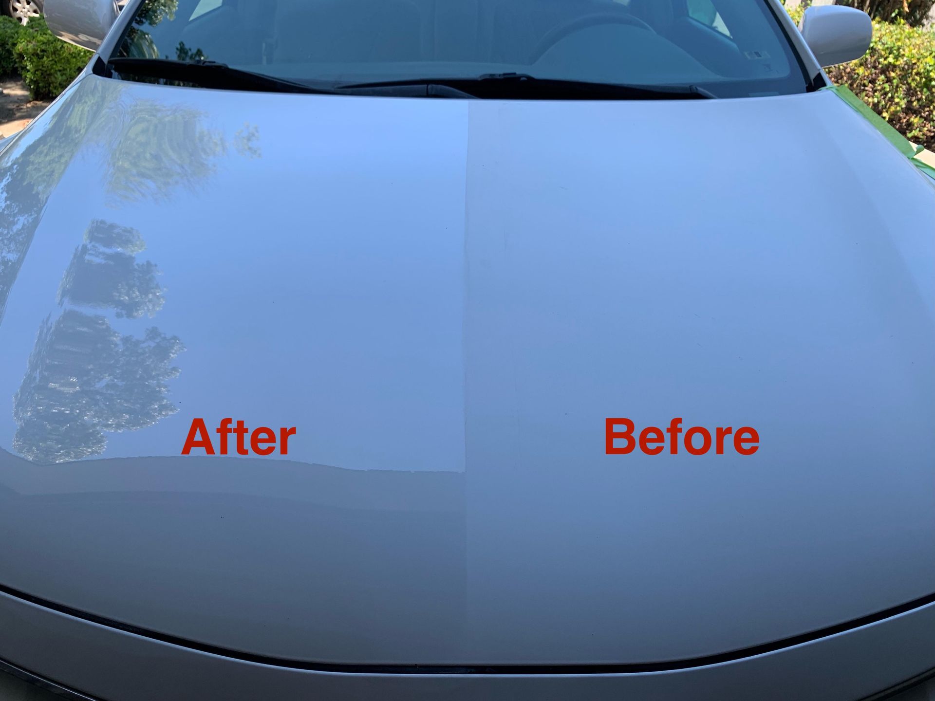 Split-screen view of a white car hood showing a polished, glossy section compared to an unpolished, matte section.