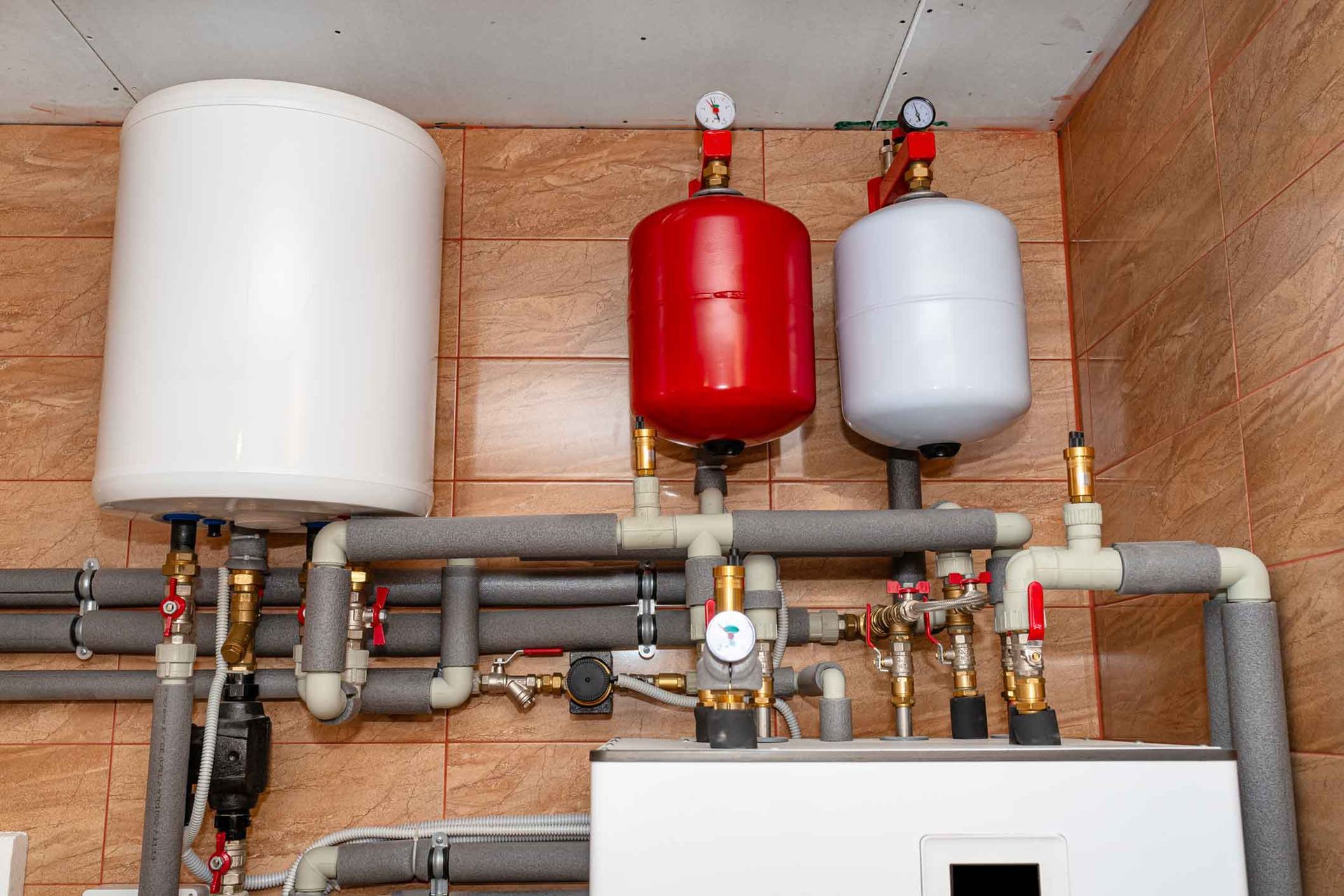 A room with a lot of pipes and tanks on the wall.