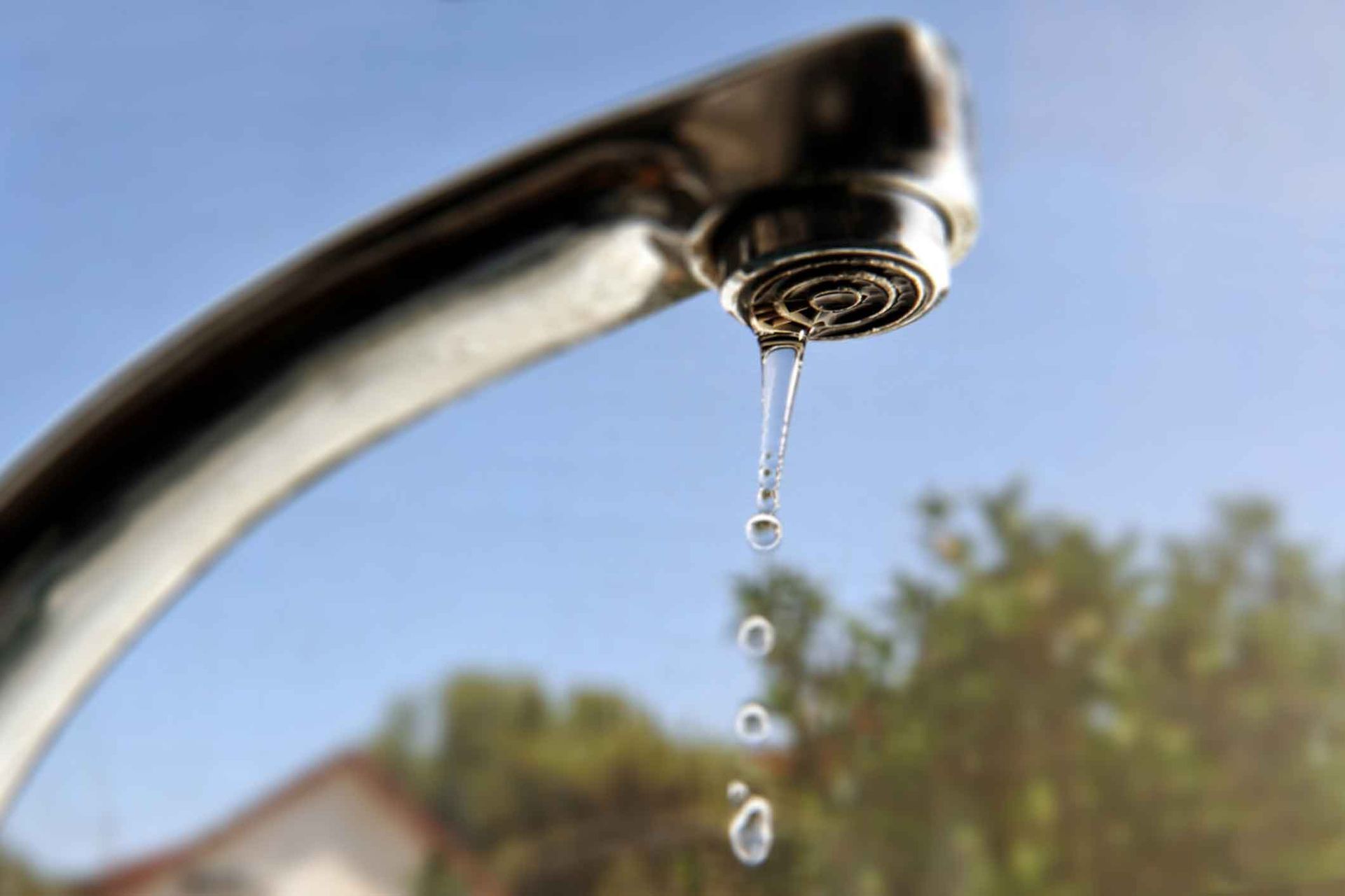 A close up of a faucet with water dripping from it