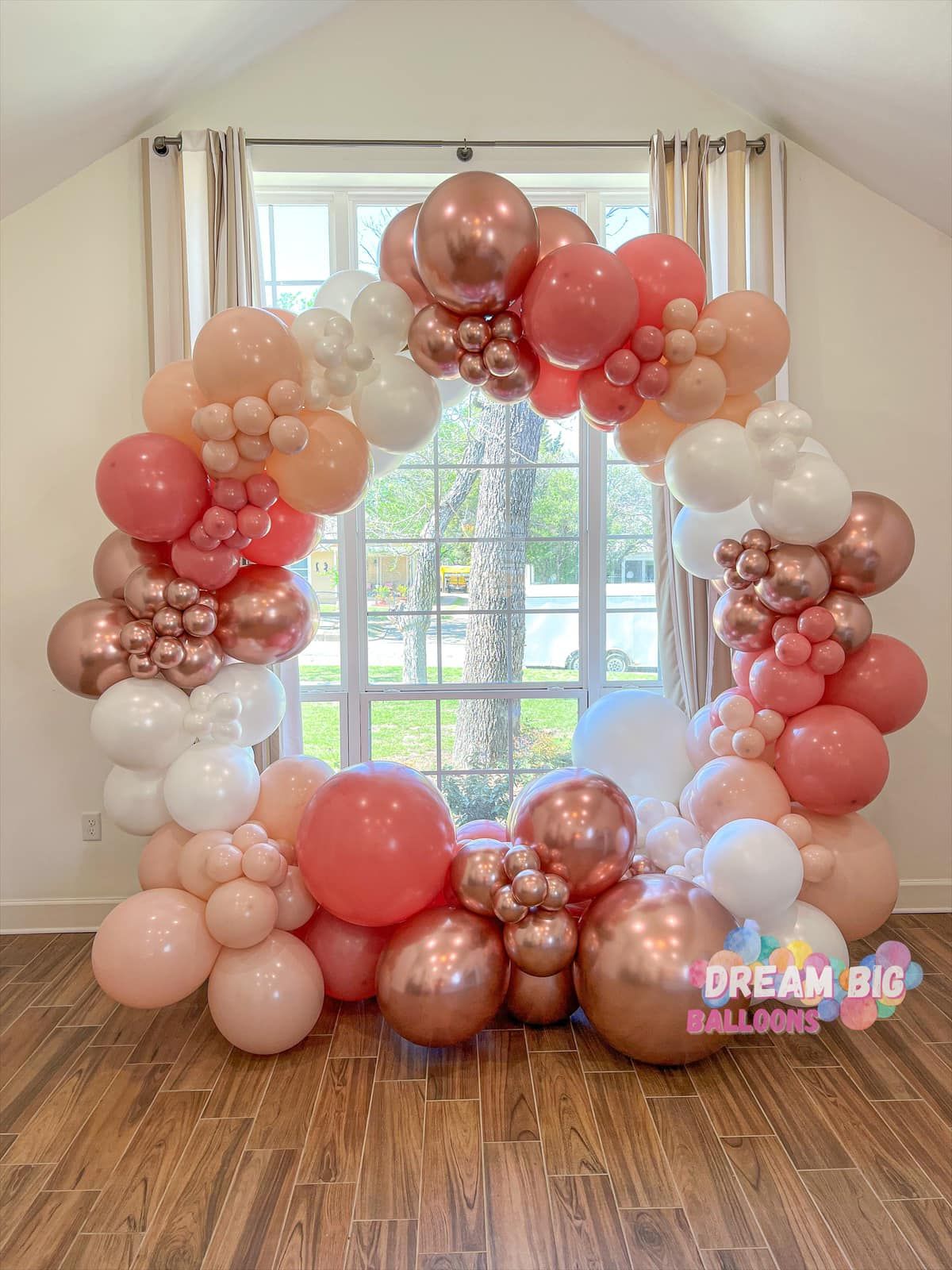 a room filled with balloons in front of a window