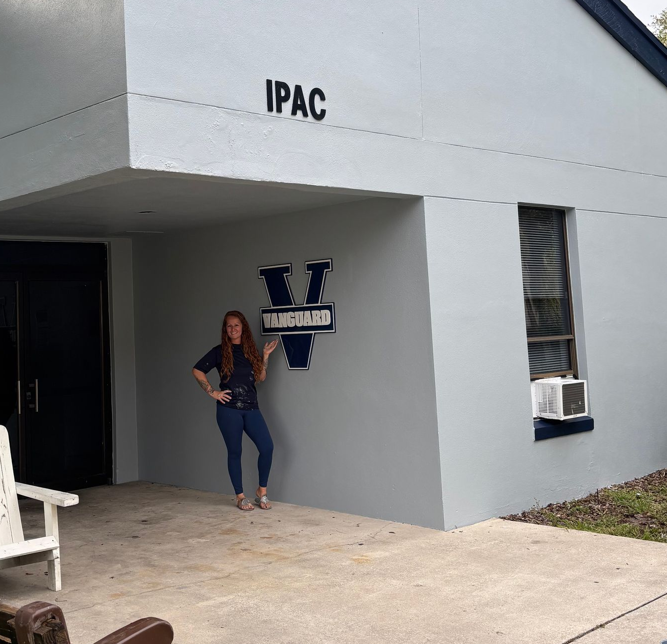 A large empty garage with the words `` orange blossom painting '' written on the floor.