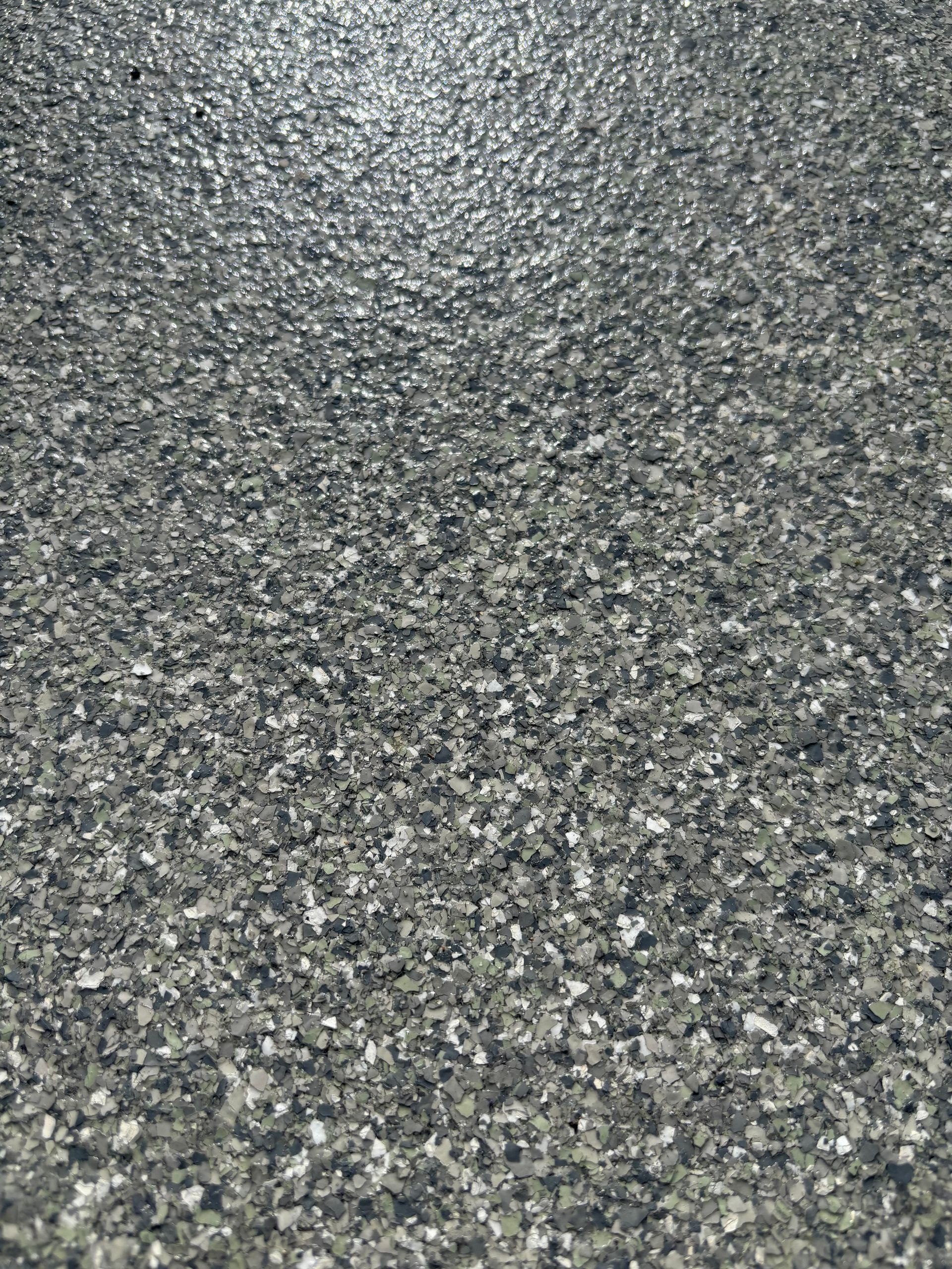 Close-up of rough gray and black speckled asphalt texture