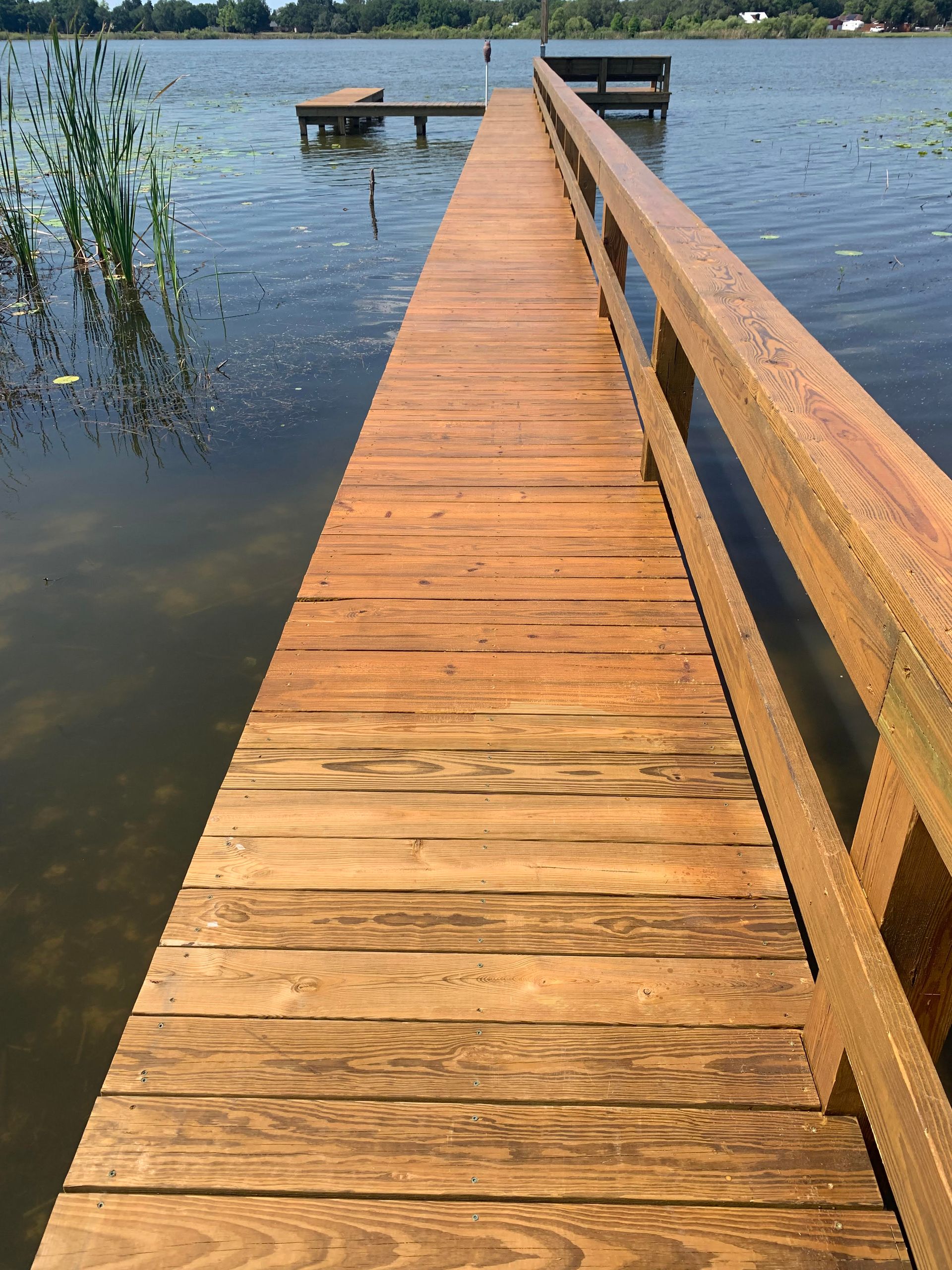 A man is sweeping the asphalt with a broom.