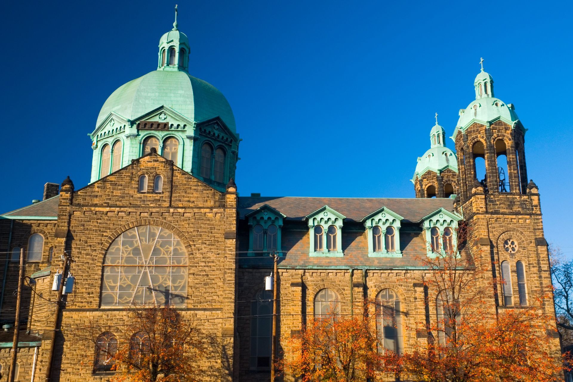 A large brick building with a green dome on top