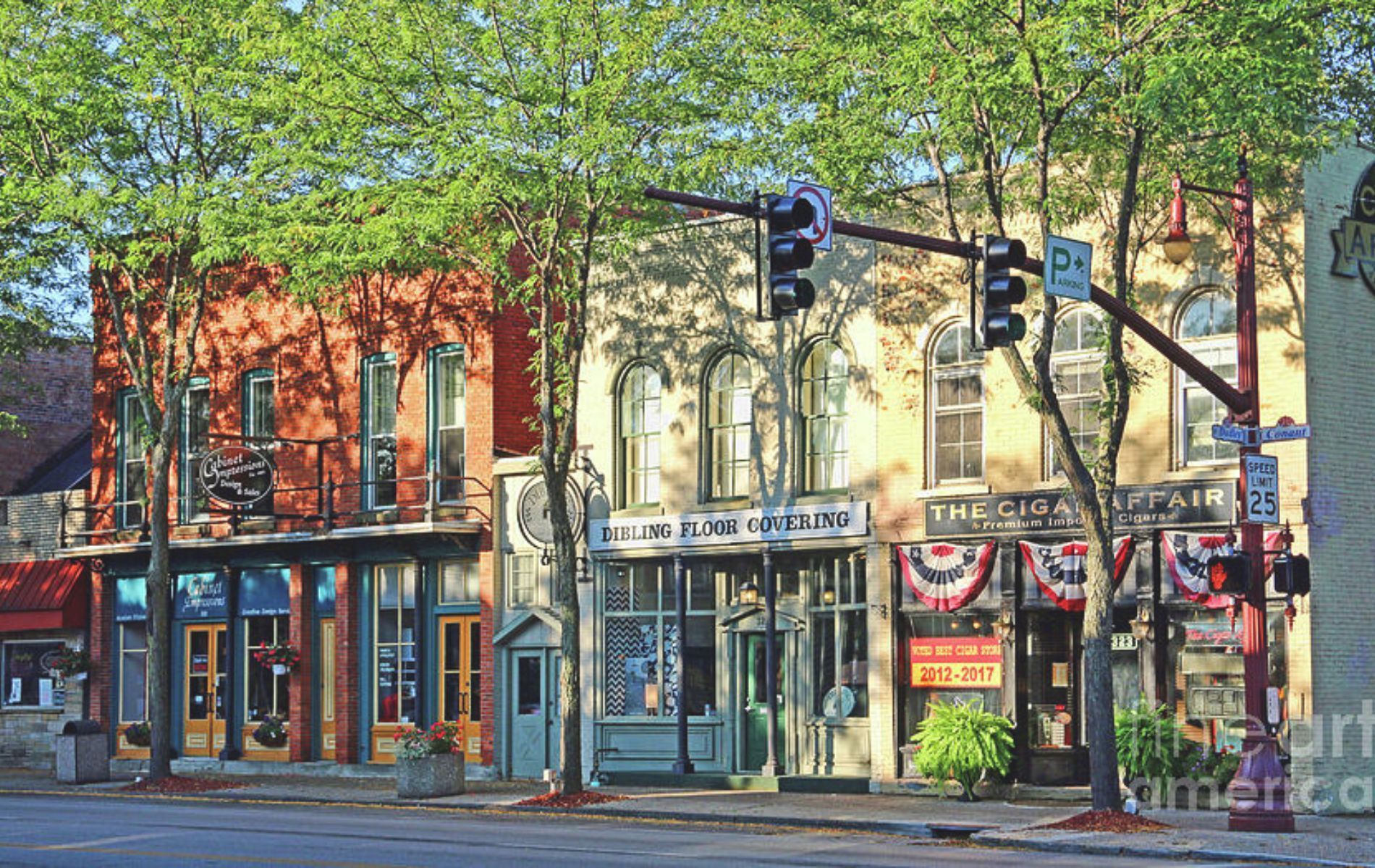A row of shops are lined up on the side of a street.