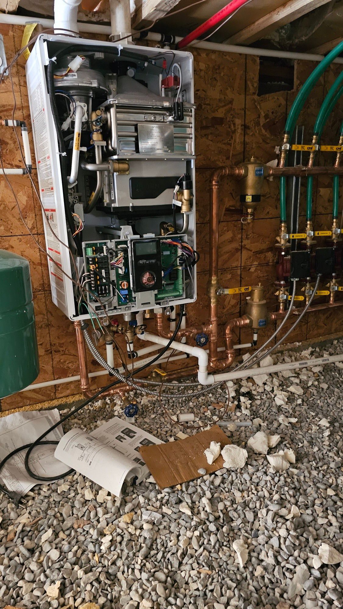A water heater is being installed in a basement.