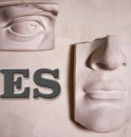 A statue of a man 's face with the word jesus on it. A statue of a man 's face with the word jesus on it.