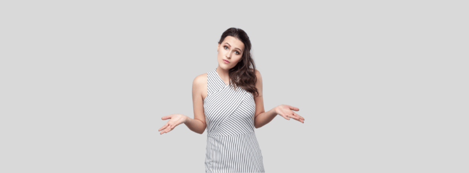 A woman in a striped dress is shrugging her shoulders.