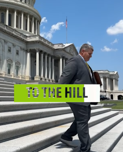 Man in suit walks up Capitol steps; 