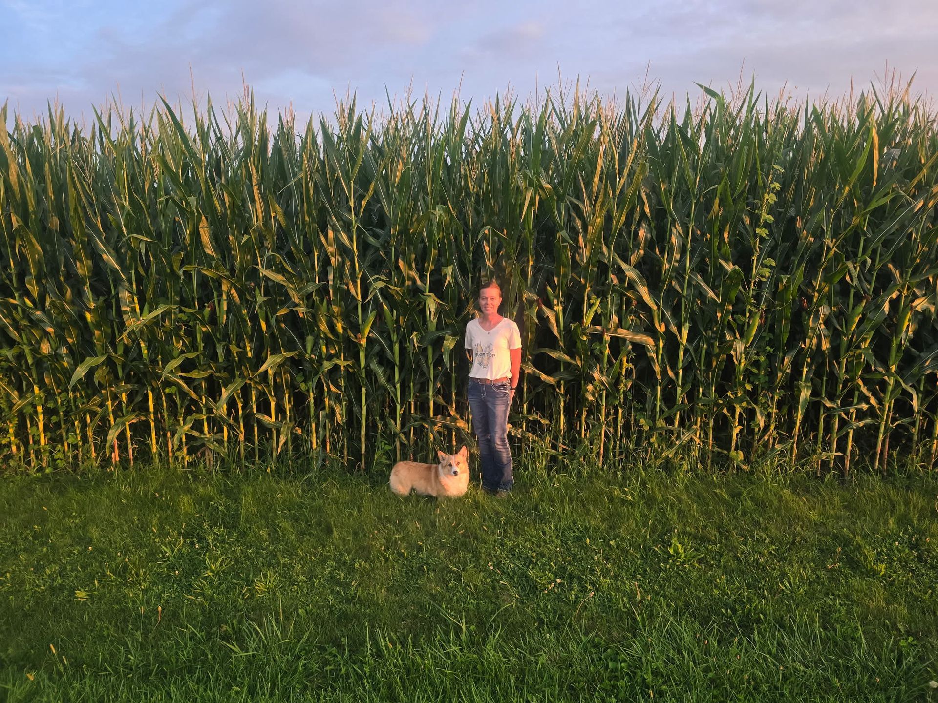 Illinois farmer sarah hastings outside of her corn with her dog