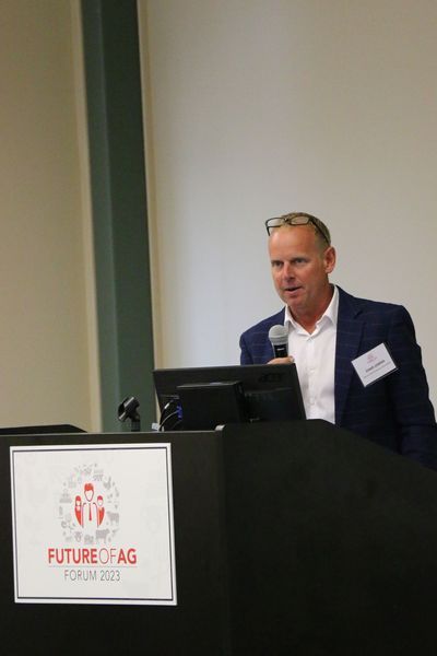 A man is standing at a podium giving a presentation.