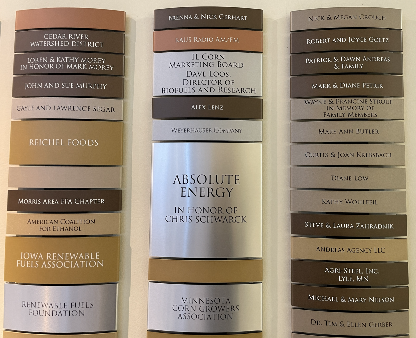Three vertical office directory panels on a wall; names and company titles listed.