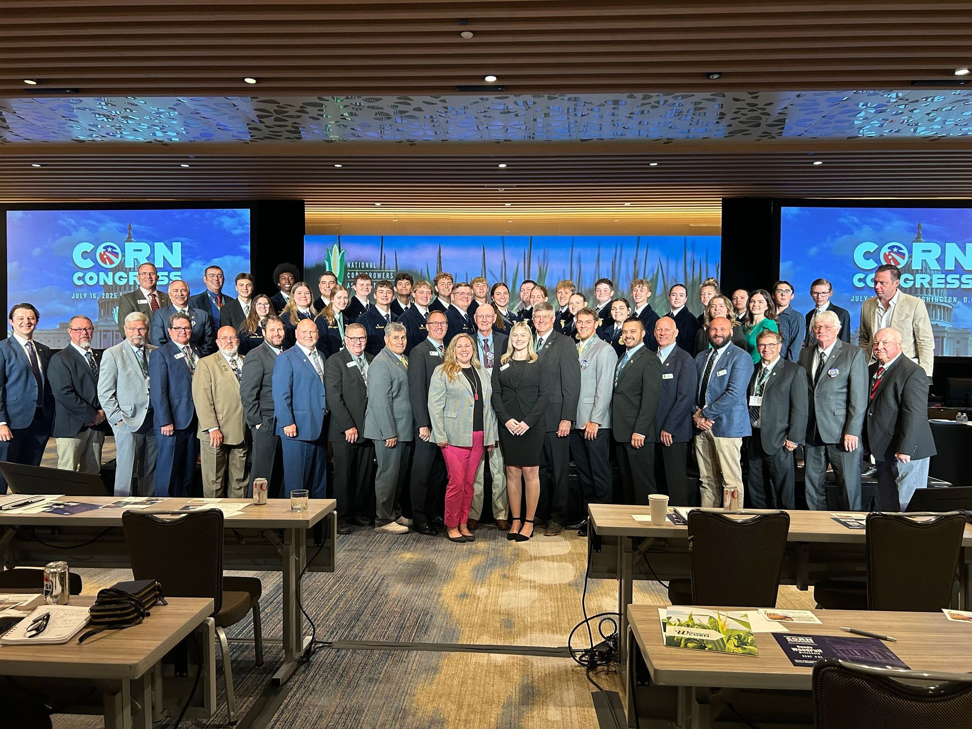 Group photo at the Corn Congress. People in business attire stand in a conference room.