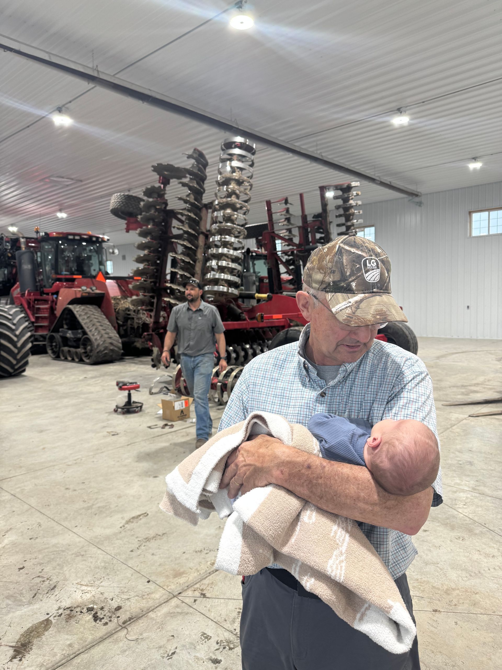 Grandpa Head with Dad Alex in background at farm shop