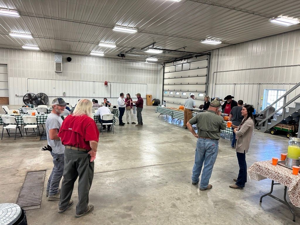 people inside farm shed talking