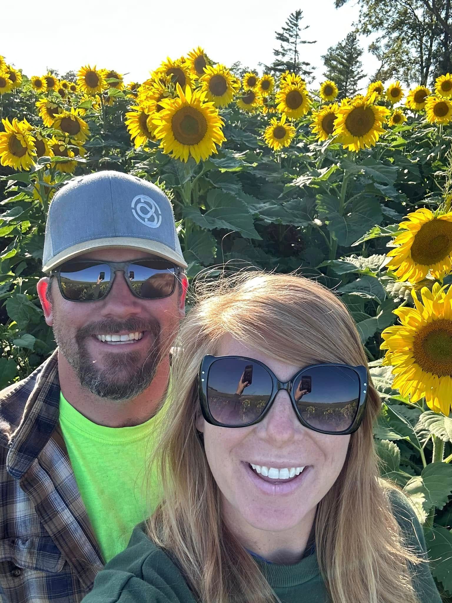 kate and her husband outside flowers