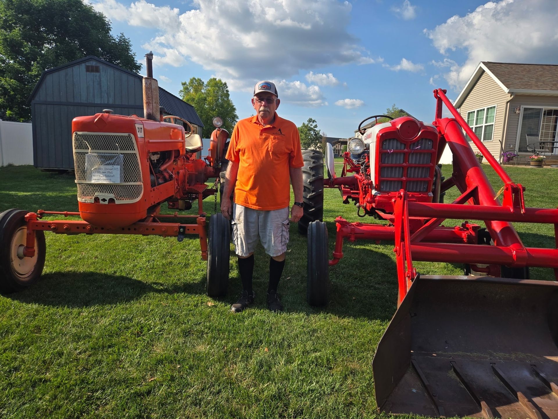 Kent in front of vintage farm machinery