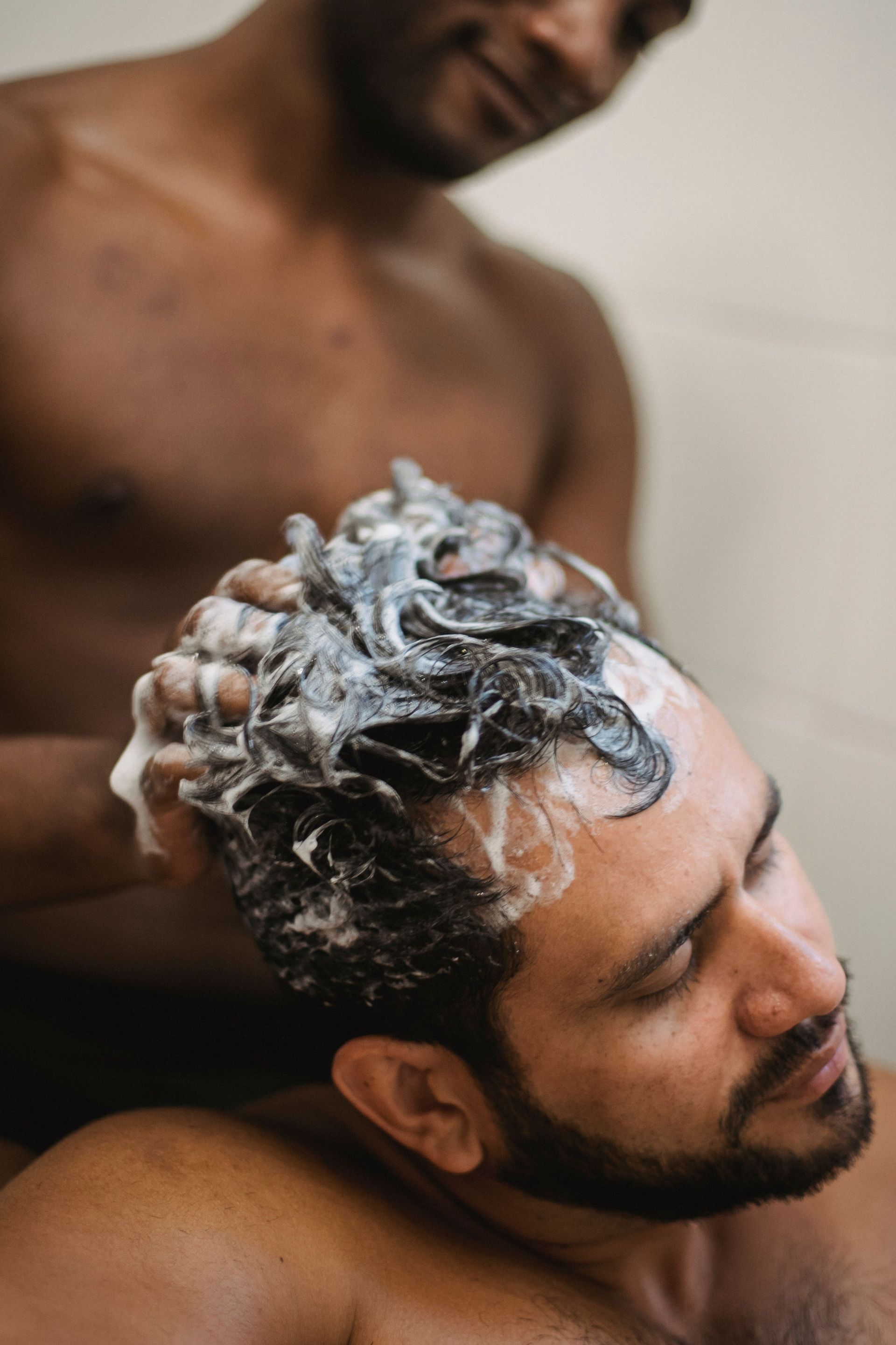 guy getting hair shampooed