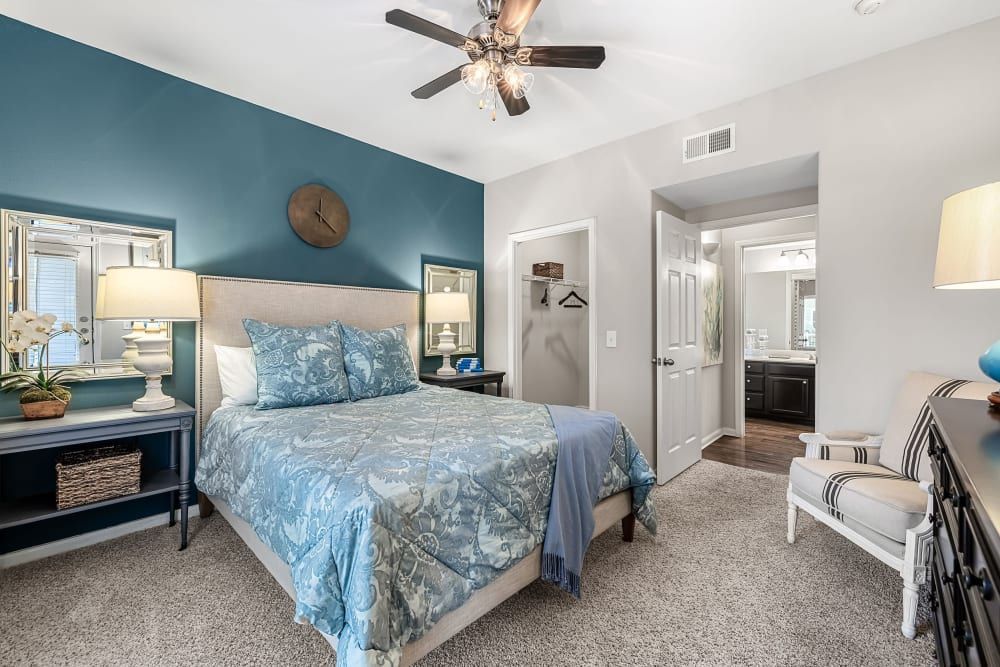 a bedroom with a king size bed and a ceiling fan at Marquis on Westheimer in Houston, TX.