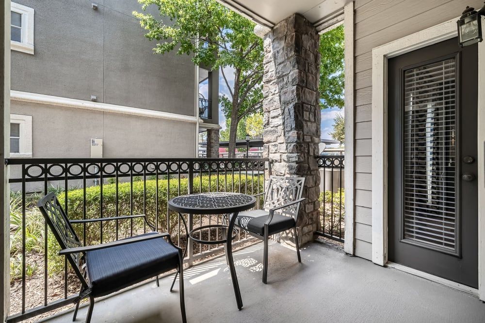 a balcony with a table and chairs on it at Marquis on Westheimer in Houston, TX.