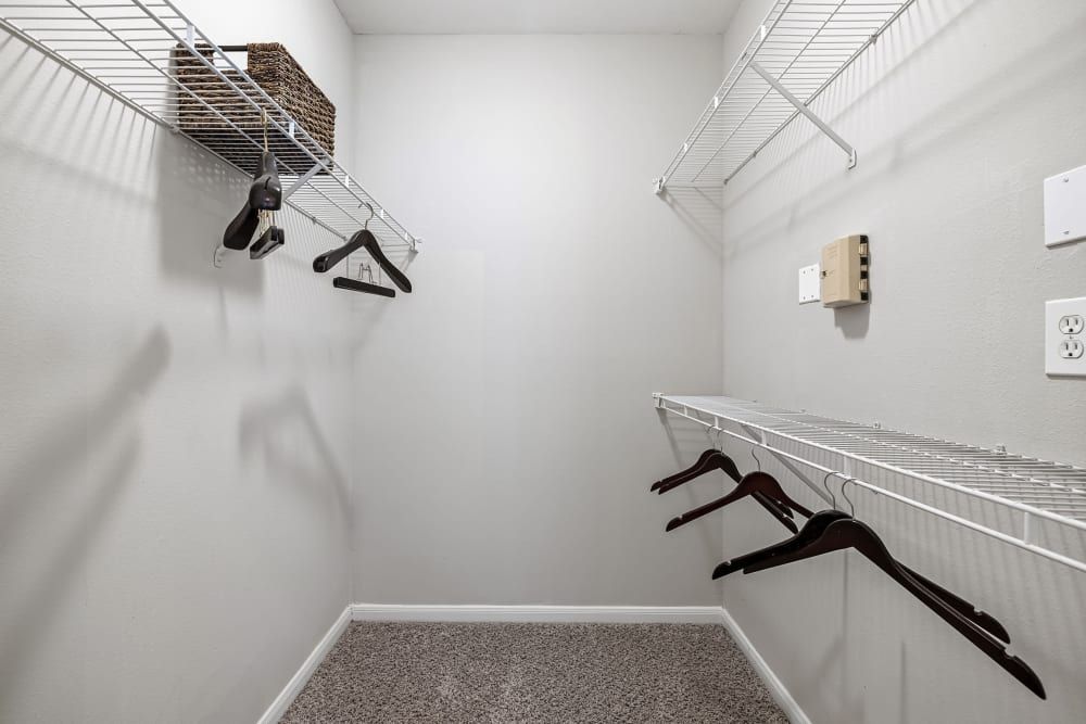a walk-in closet with a lot of shelves and hangers at Marquis on Westheimer in Houston, TX.
