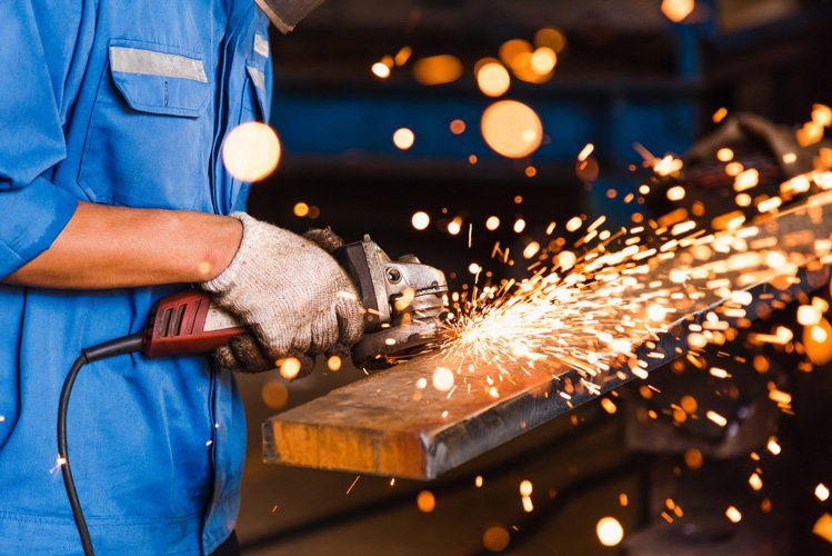Wheel Grinding On A Steel Plate — Steel Fabricators in Dubbo, NSW