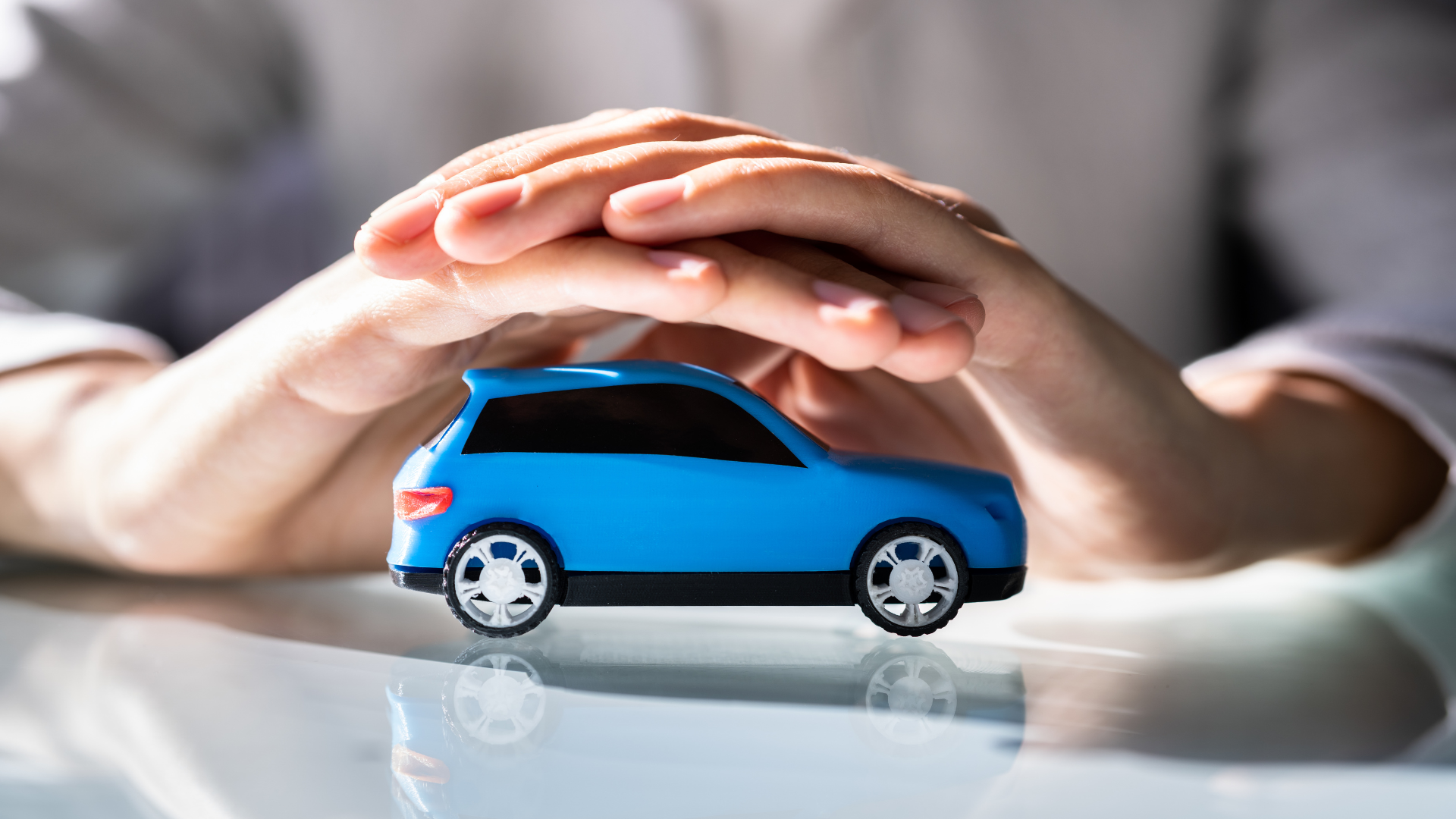 A woman is sitting in the driver 's seat of a car.