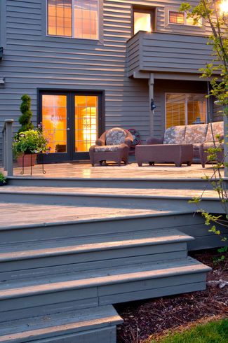 A house with a deck and stairs leading up to it A house with a deck and stairs leading up to it
